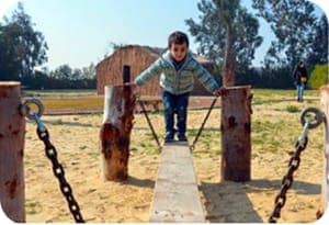 A young boy playing outdoors.