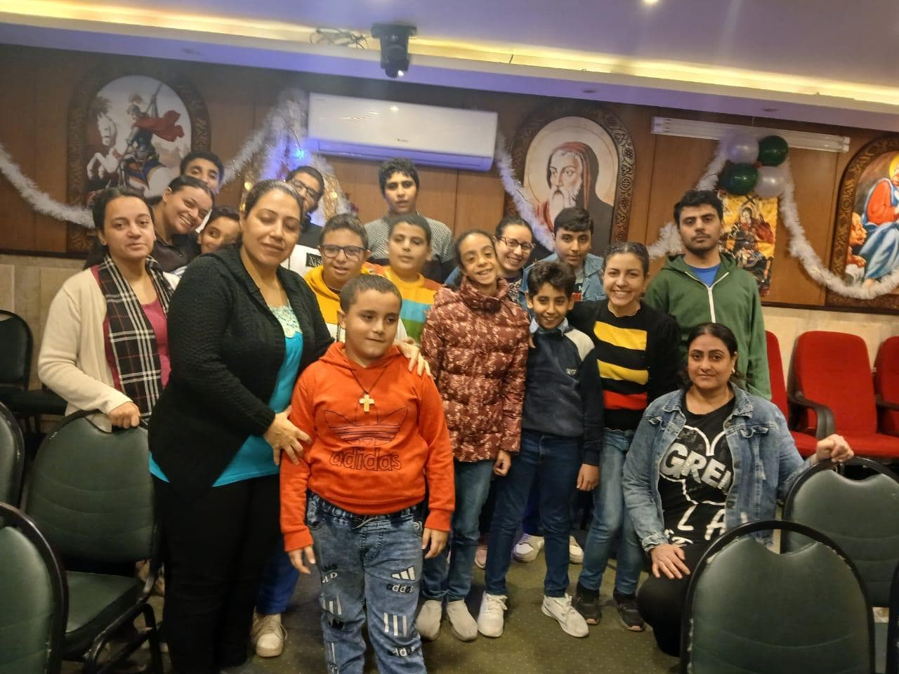 A group of children and staff participating in community programs for the Coptic disabled community in Egypt
